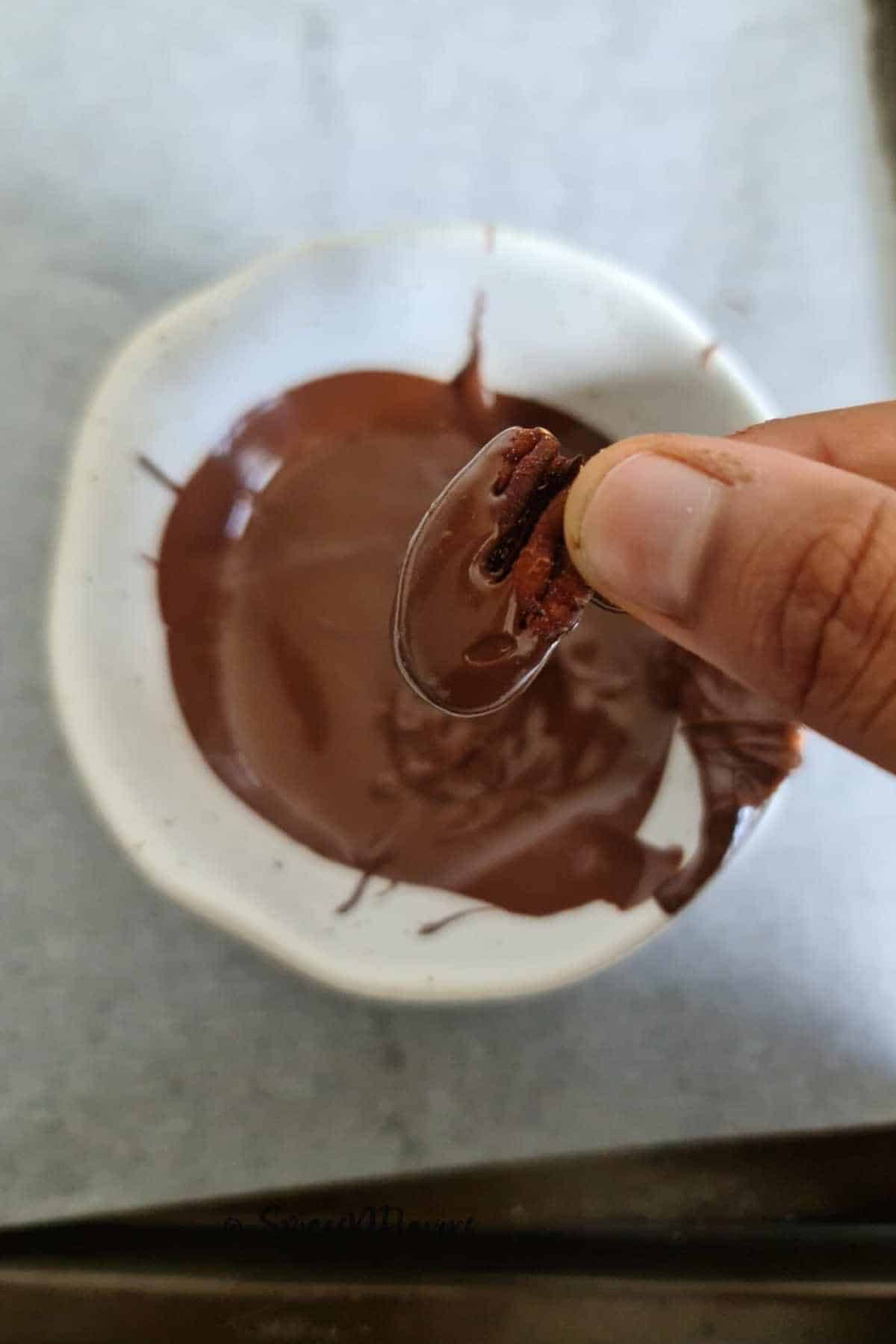 dip pecans into chocolate