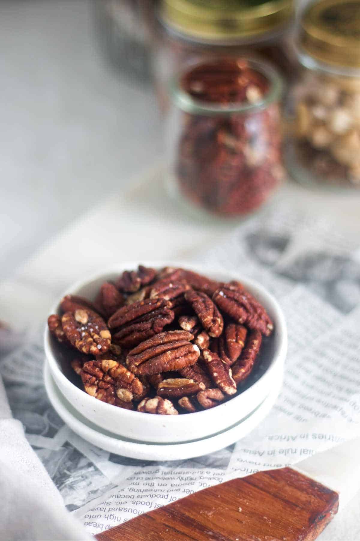 pecans roasted in air fryer placed in a white bowl