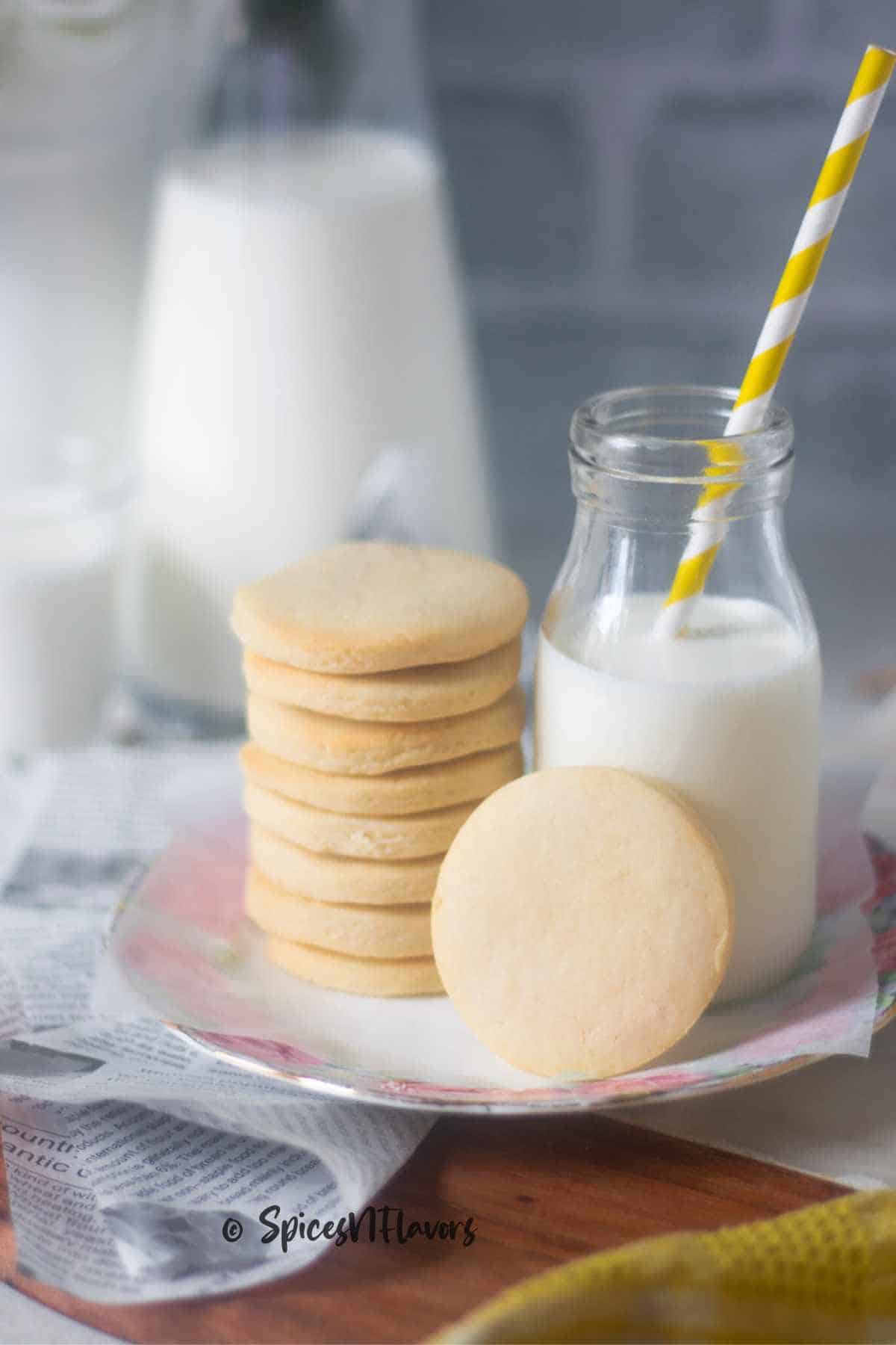 stacked eggless air fryer sugar cookies with a milk bottle on the side
