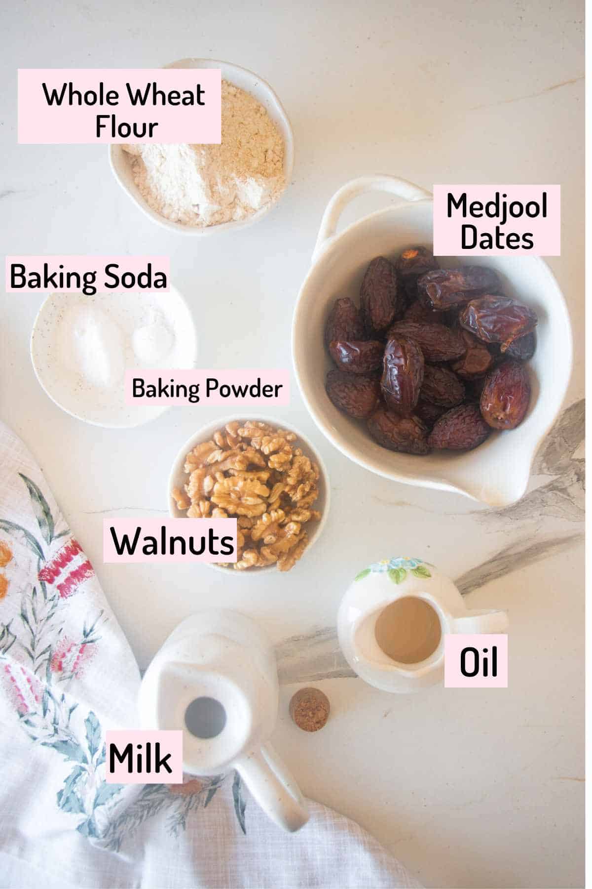 ingredients needed to make the date and walnut cake placed on marble slab