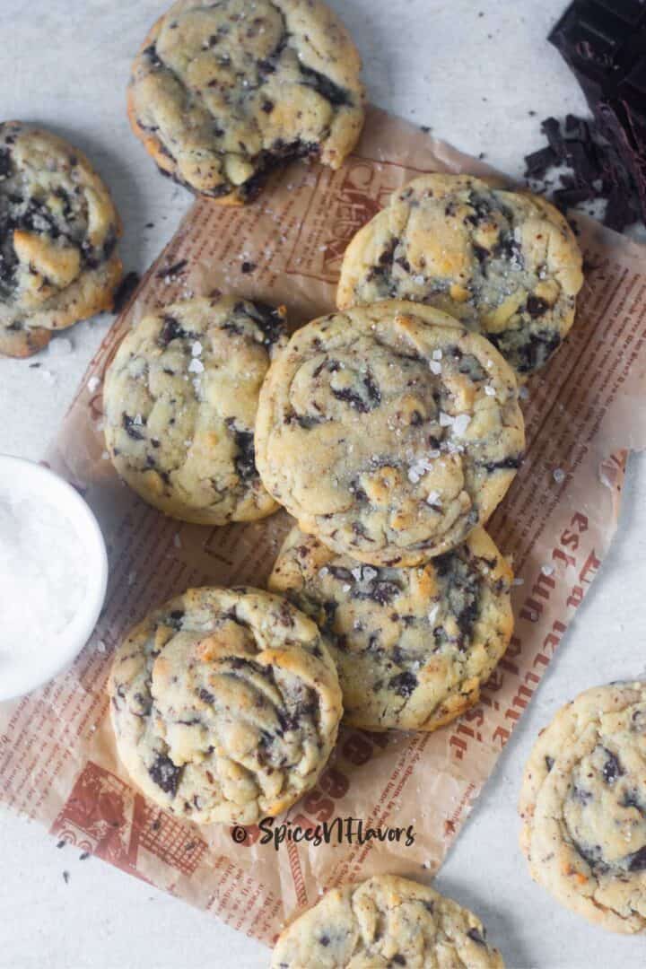 baked chocolate chip cookies placed on a brown parchment paper