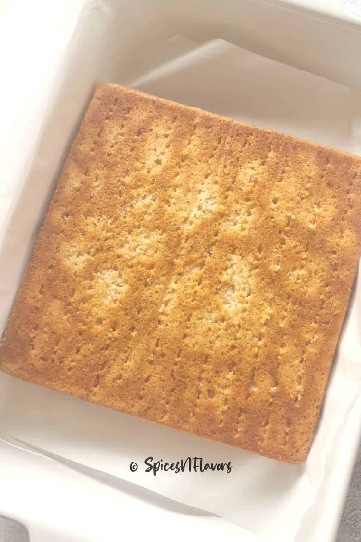 square shaped vanilla sponge cake placed in a casserole