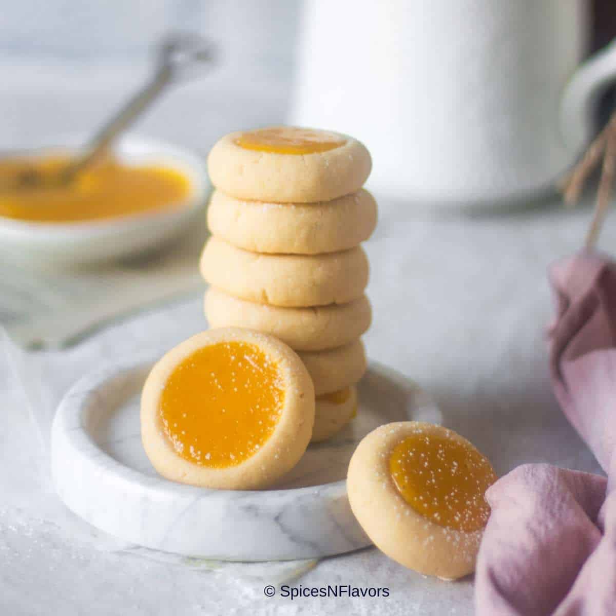 close up image of lemon curd cookies stacked on each other to fit recipe card