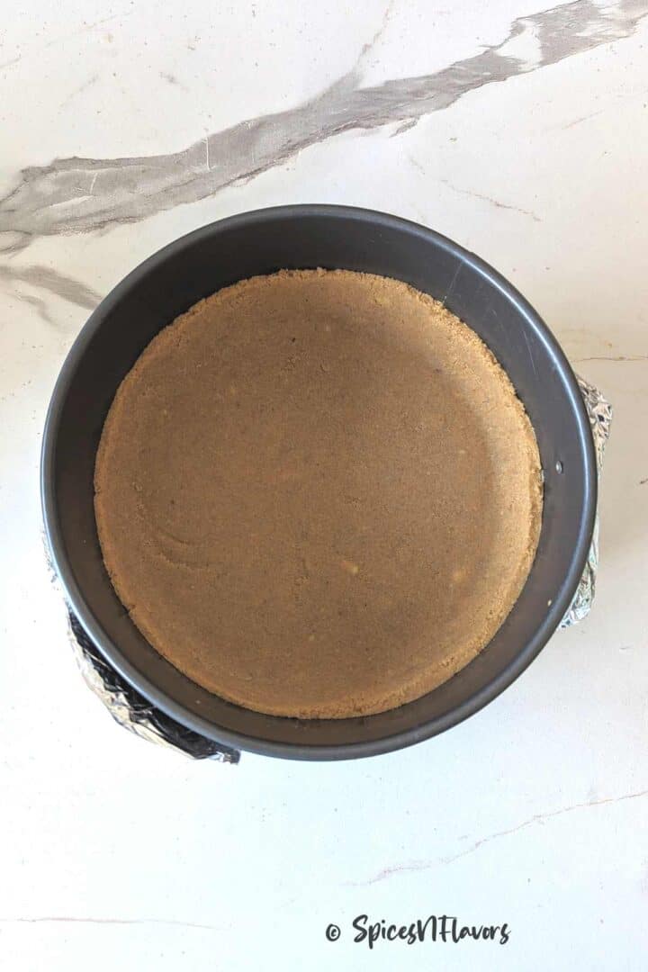 springform pan lined with the prepared biscuit base crust