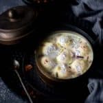 cropped up image of rasgulla rasmalai placed in the tiffin box to fit the recipe card image size