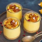 3 jars filled with gulab jamun custard placed on a plate