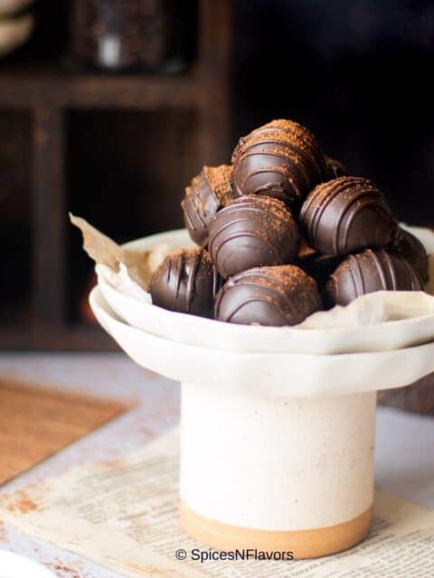 cropped image of coffee truffles placed on a plate to fit the recipe card image size