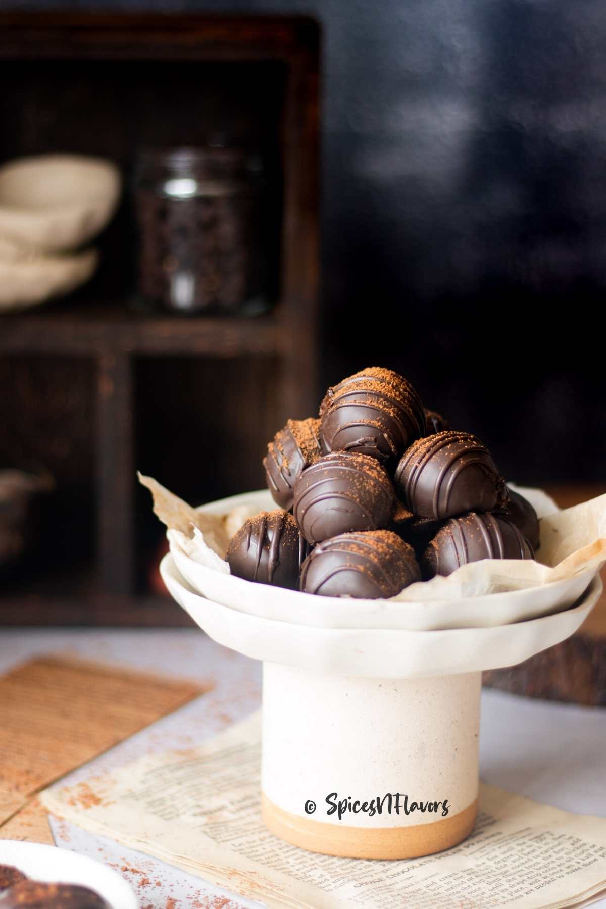 cocoa dusted coffee truffles placed on a small diy cake stand 
