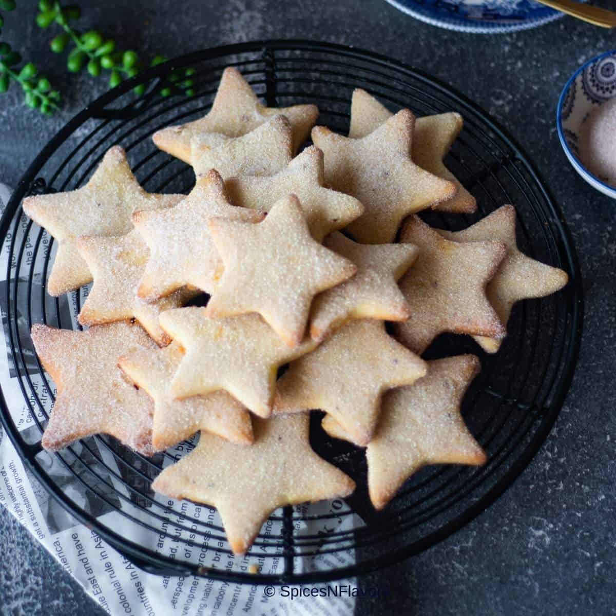 close up image of star cookies arranged on a wire rack to fit the recipe card image