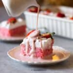 close up image of strawberry cake slice with pouring of the strawberry milk