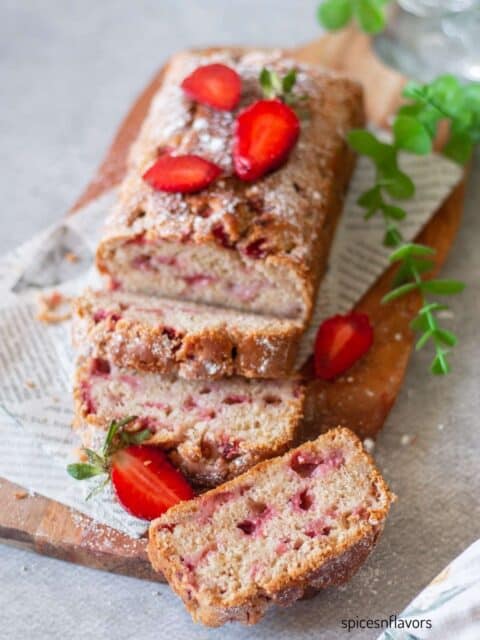 sliced strawberry bread slices on wooden board