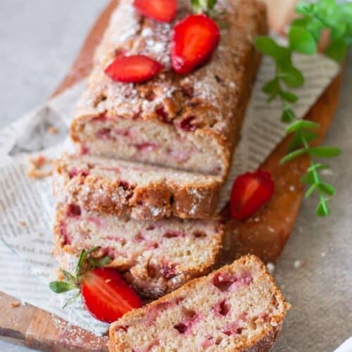 sliced strawberry bread slices on wooden board