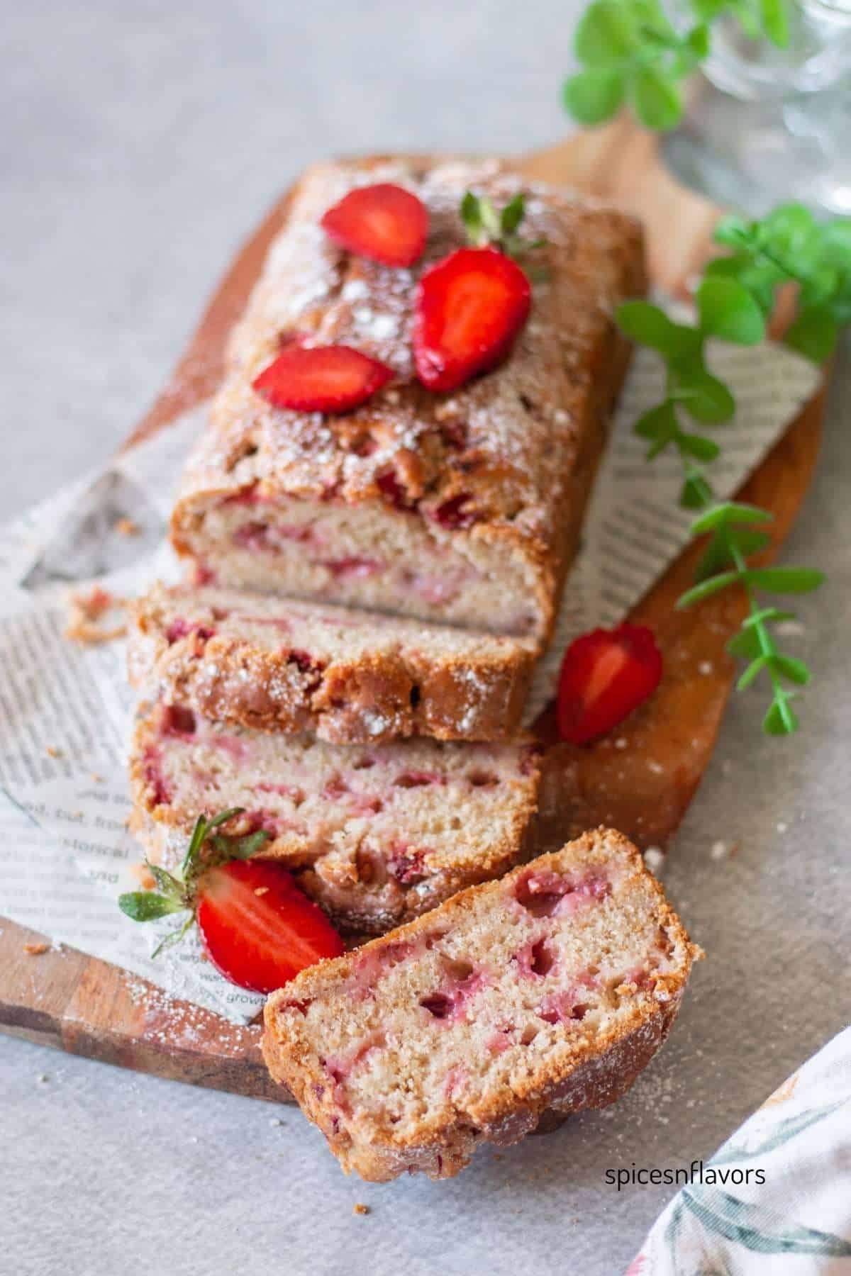 sliced strawberry bread slices on wooden board