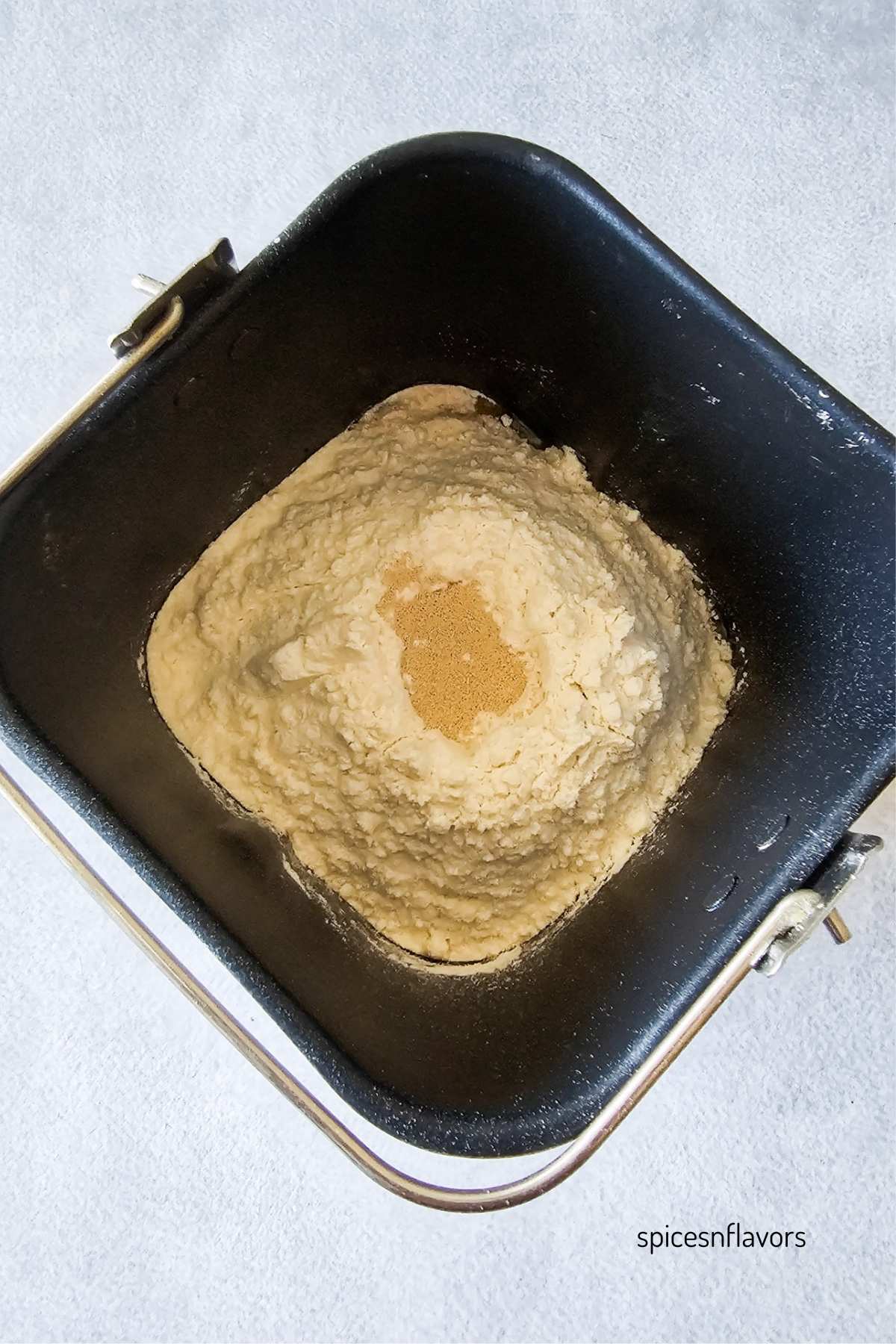 adding dry ingredients to the bread machine pan