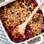 close up image of berry crisp in baking dish for recipe card image