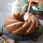 close up image of pouring strawberry glaze over pound cake for recipe card