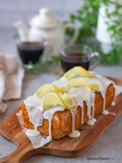 baked eggless lemon loaf cake on wooden board