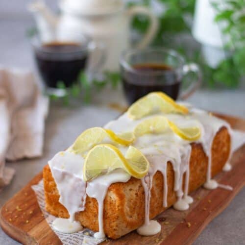 baked eggless lemon loaf cake on wooden board