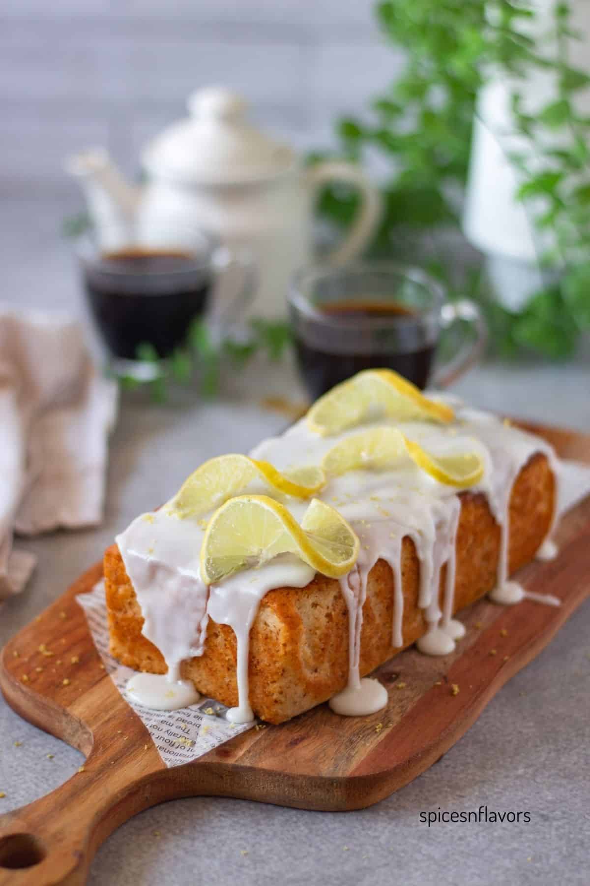 baked eggless lemon loaf cake on wooden board