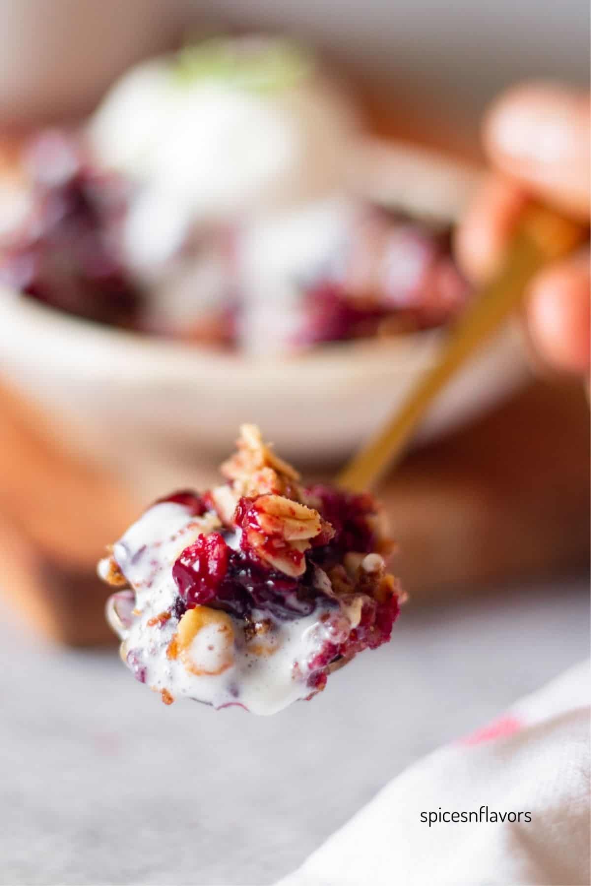spoonful of berry crisp and ice cream