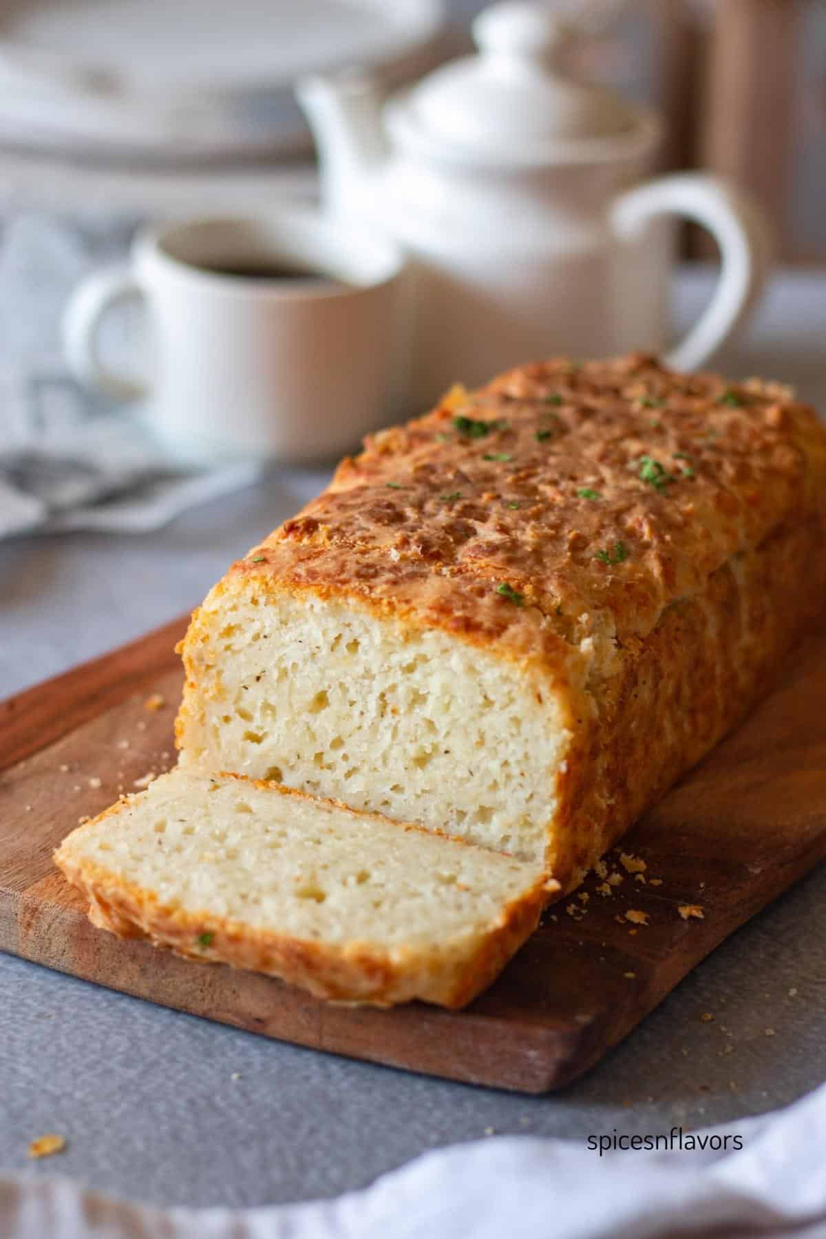 sliced cheddar cheese bread placed on a wooden board