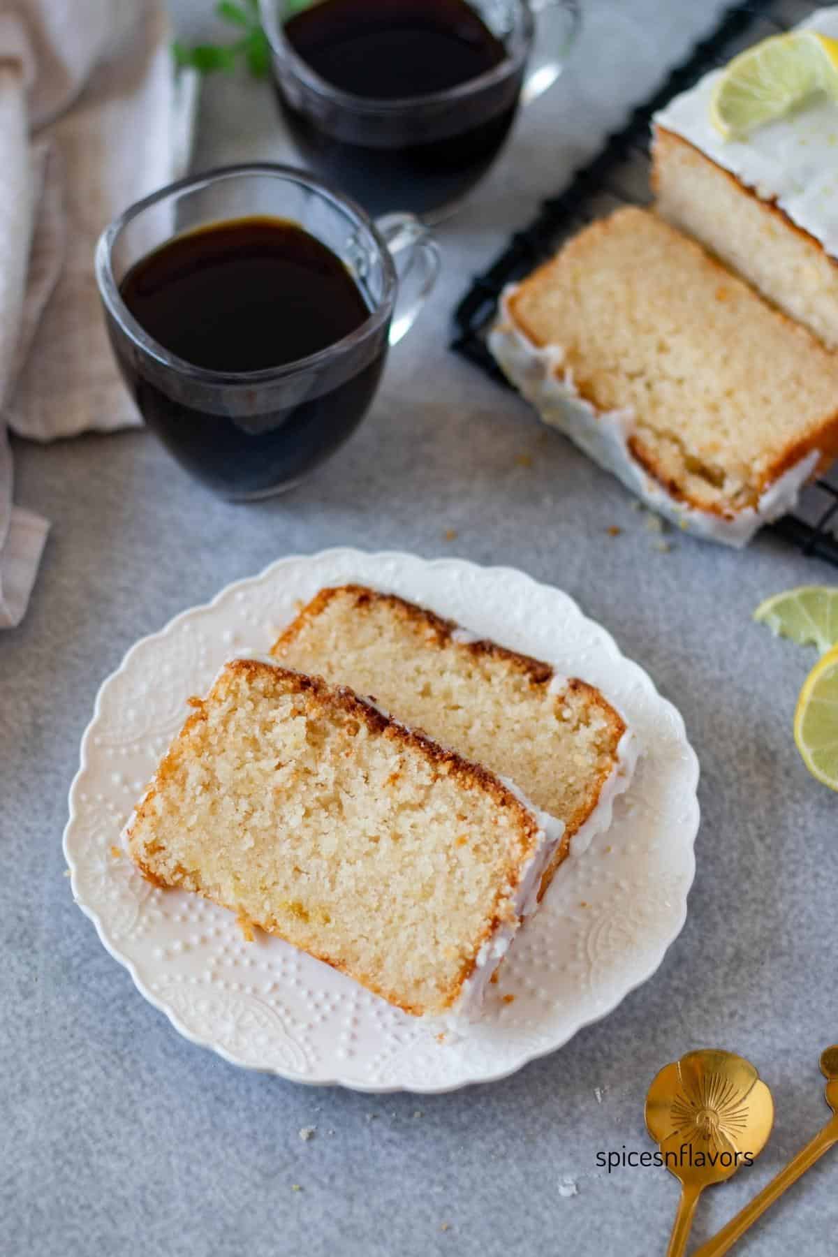 two slices of eggless lemon loaf placed on a white plate