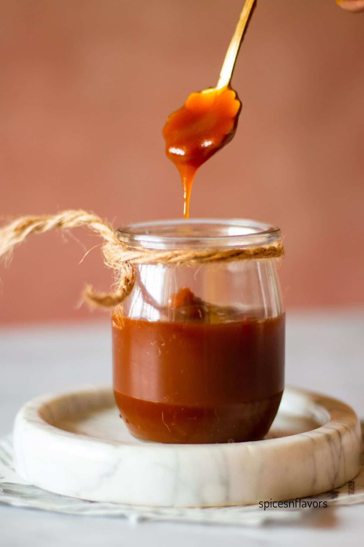 caramel sauce lifted using a flower shaped spoon