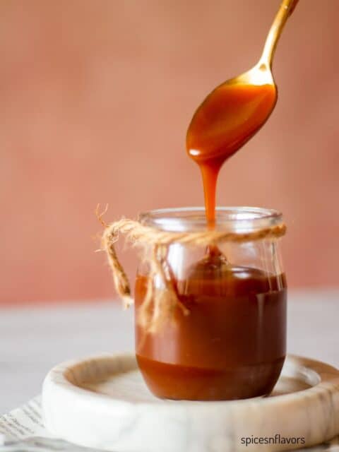 caramel sauce flowing through a large spoon showing the silkiness