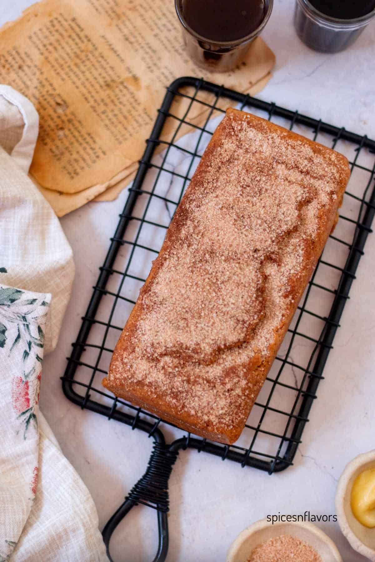 baked cinnamon sugar donut bread placed on a wire rack