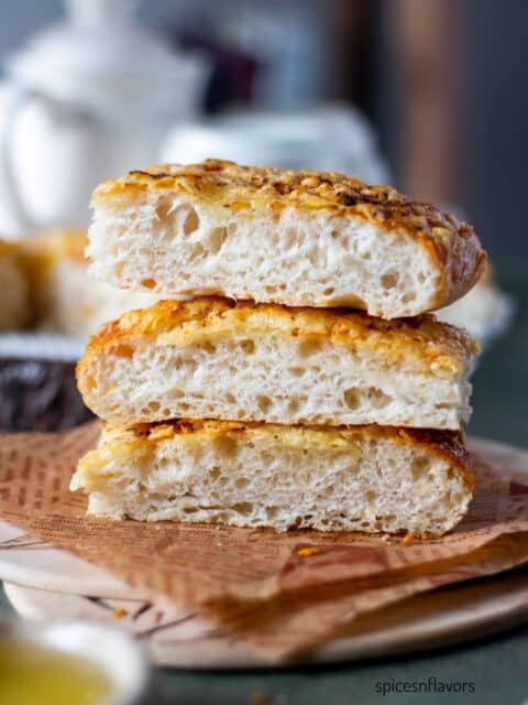 three slices of italian cheese bread placed on one top of the other