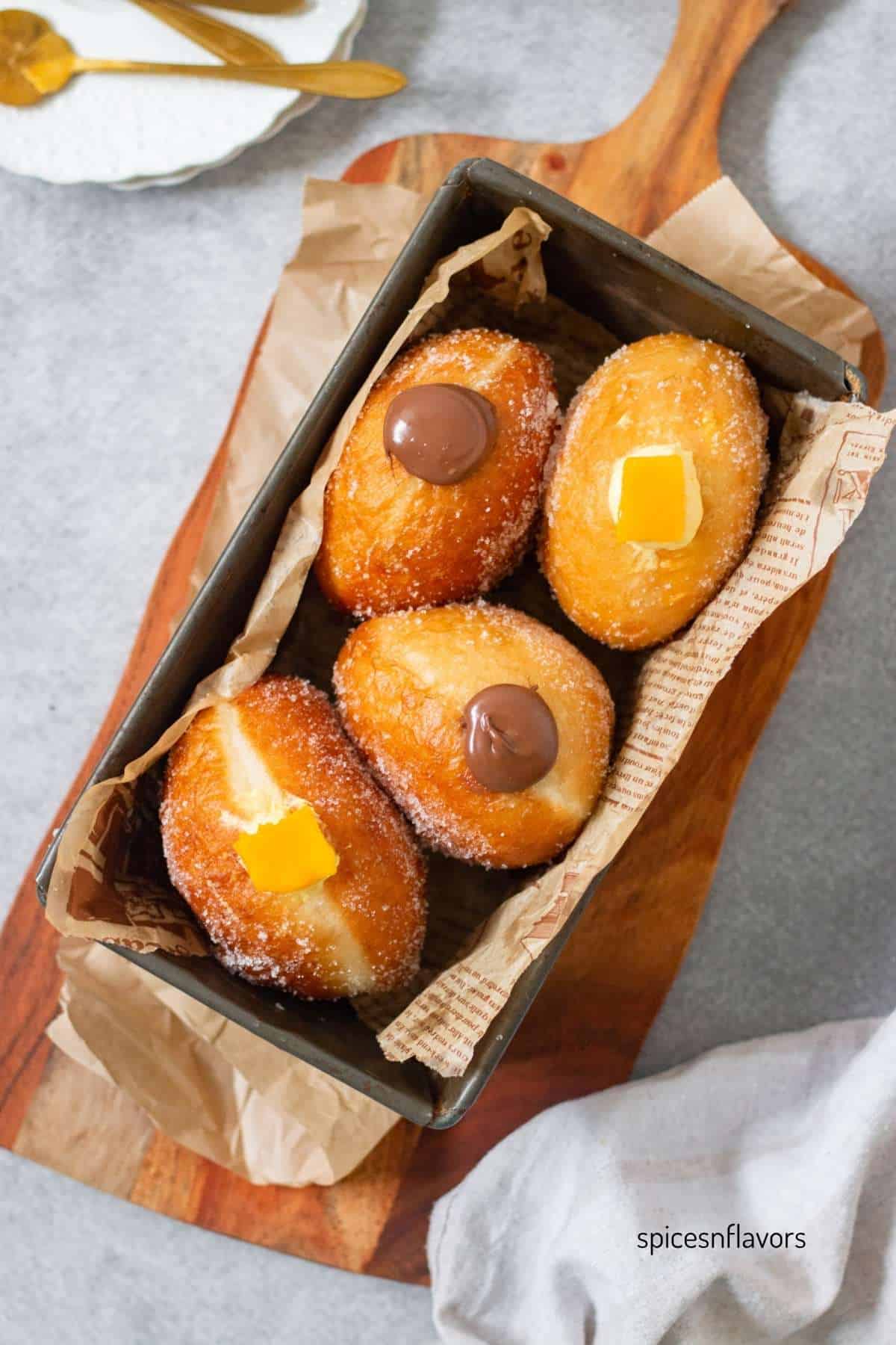 Eggless Bombolonis placed inside baking tray