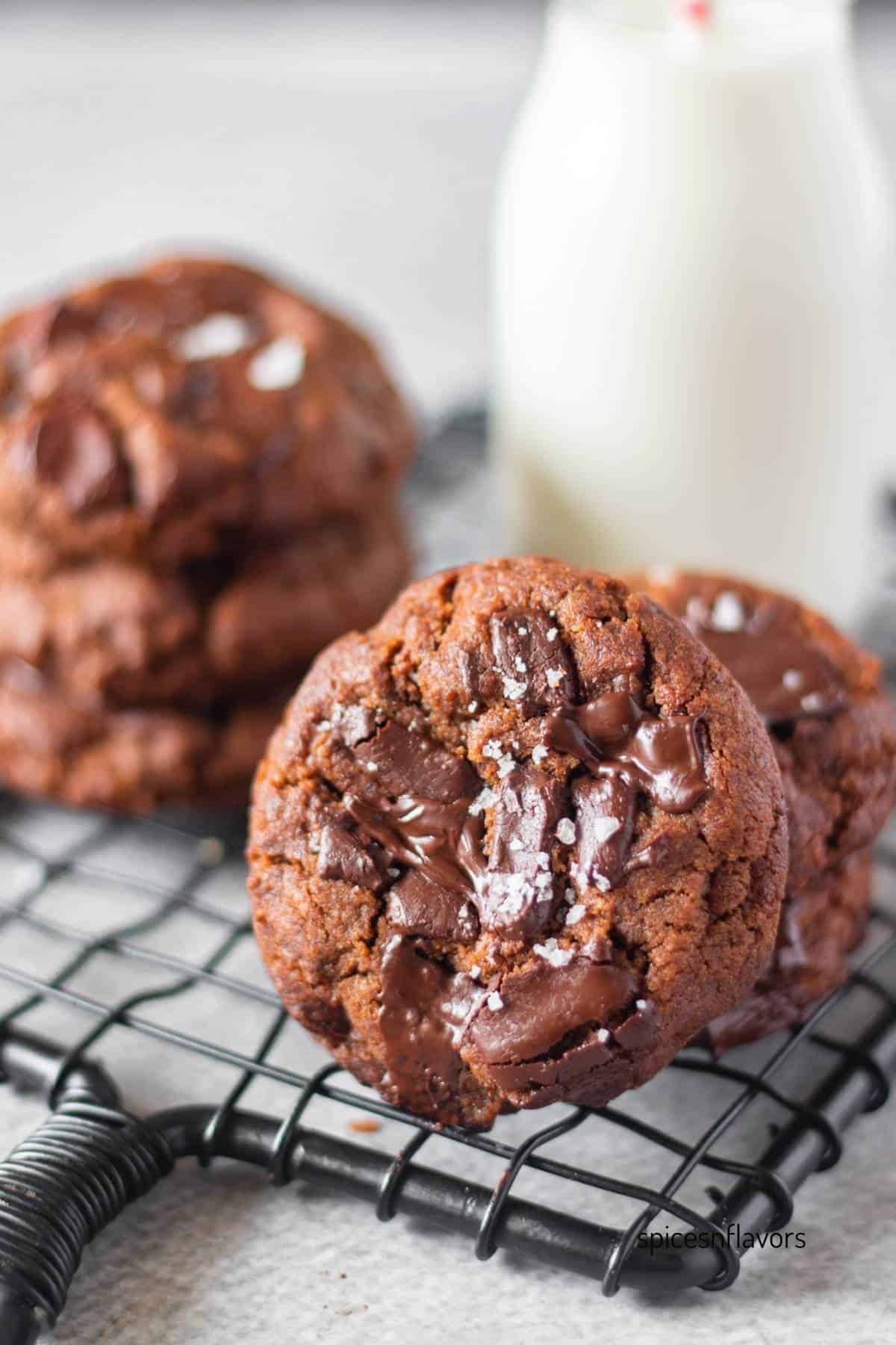 dark chocolate espresso cookies leaned over a bottle of milk
