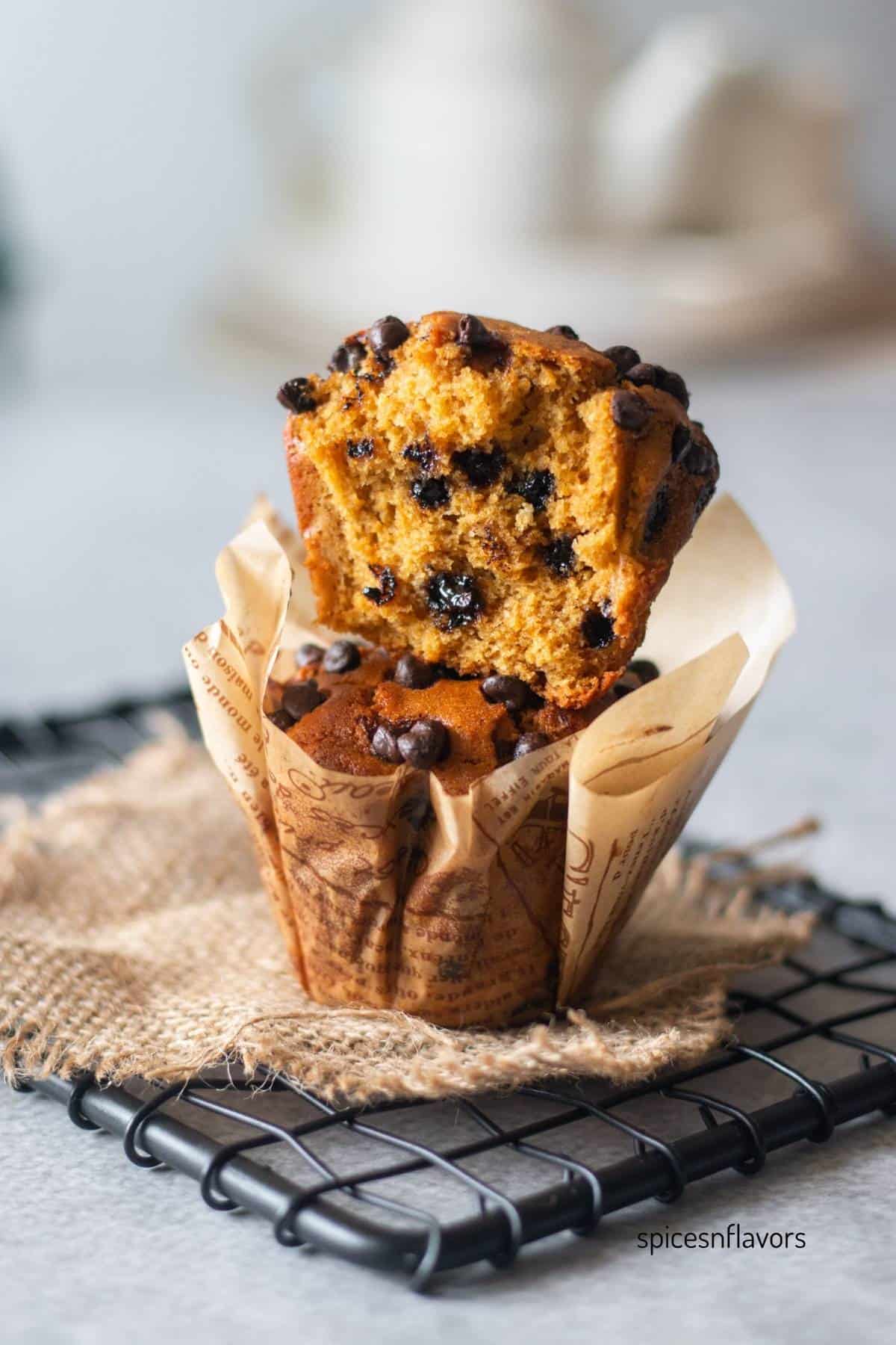 sliced muffin placed on top of another muffin to show the texture from within