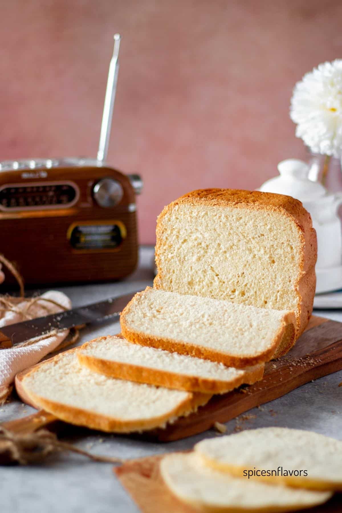 sliced loaf of japanese milk bread machine bread placed on wooden board