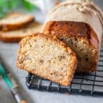 close up image of sliced banana bread on wire rack for recipe card