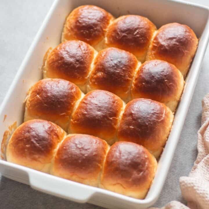 baked dinner rolls in a ceramic baking pan