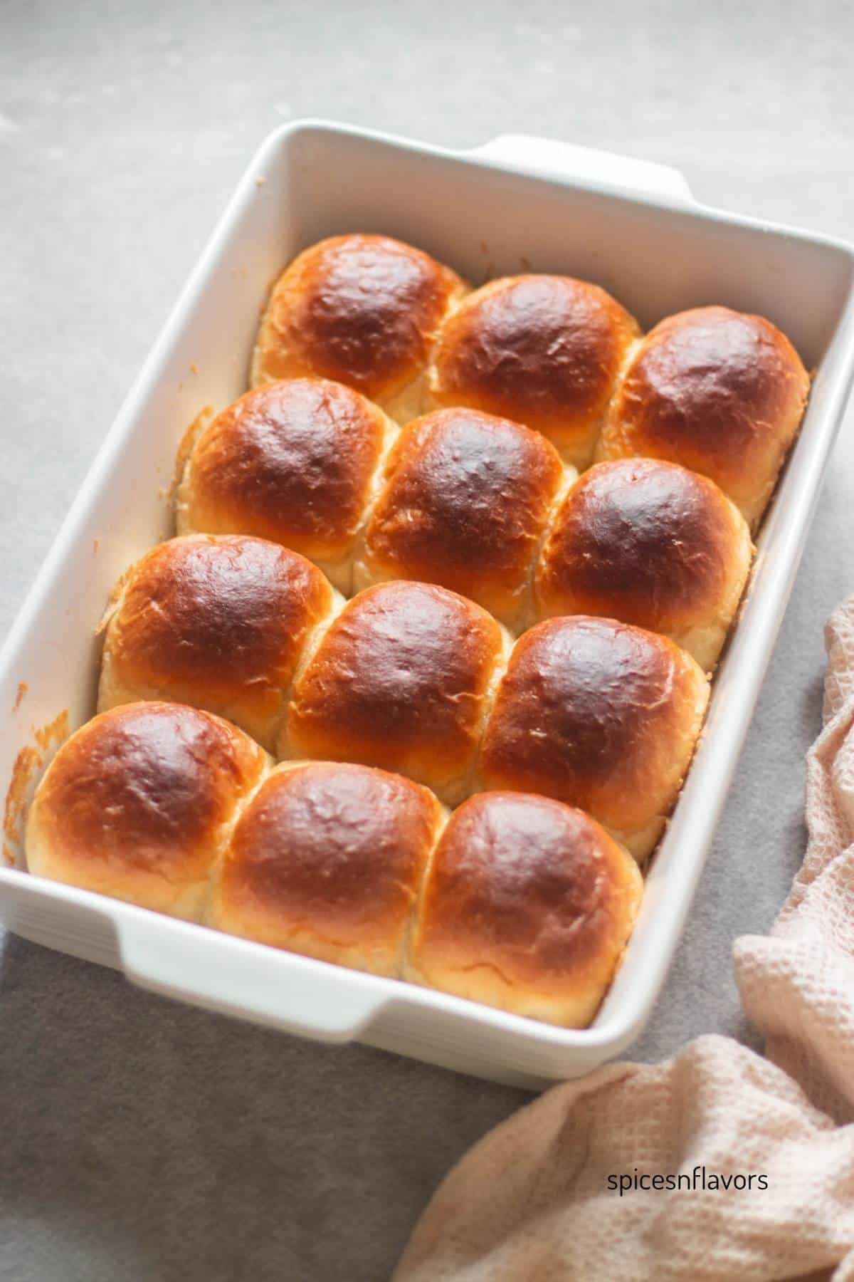 baked dinner rolls in a ceramic baking pan
