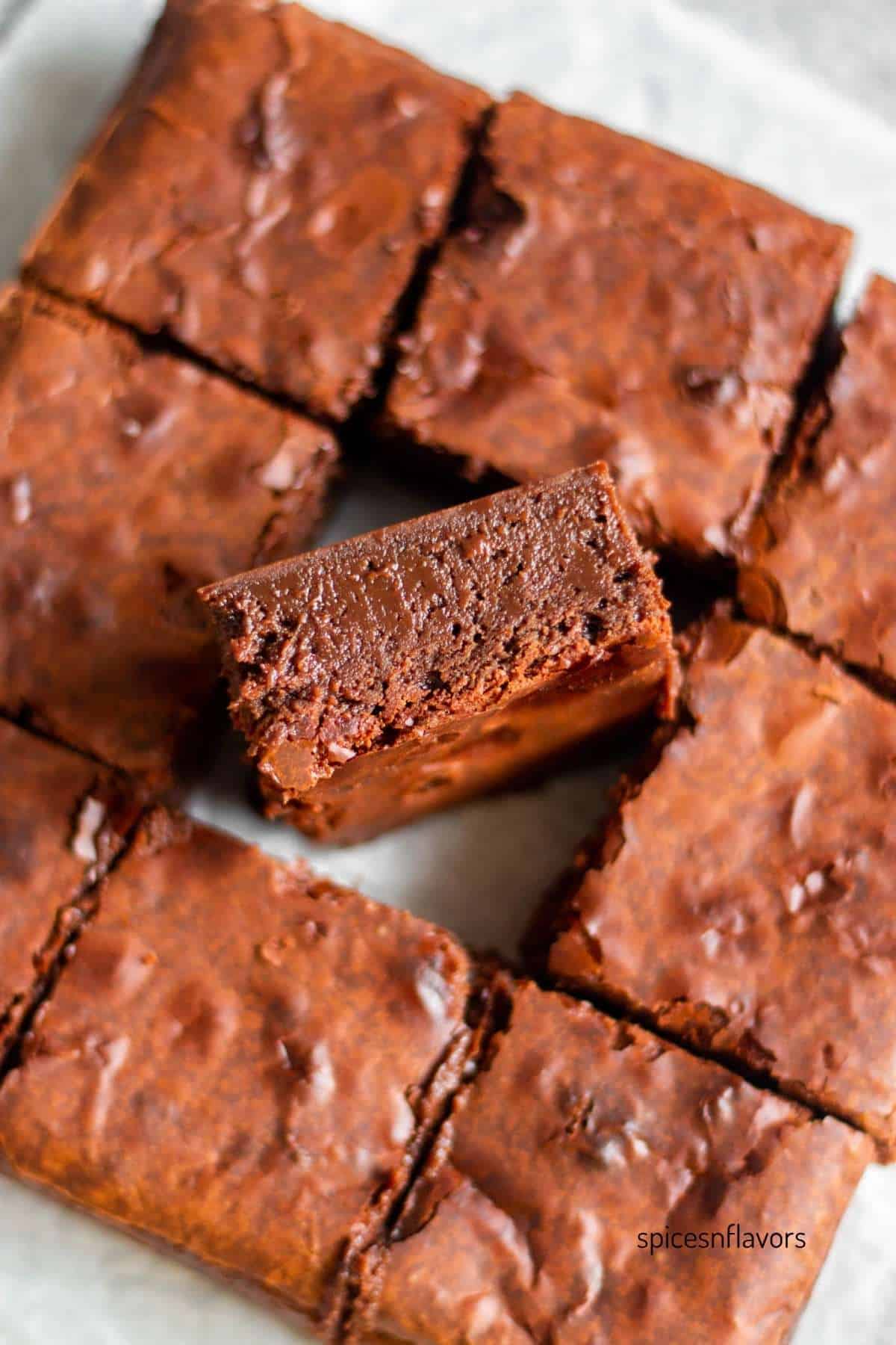 one upright brownie showing the fudgy texture of it