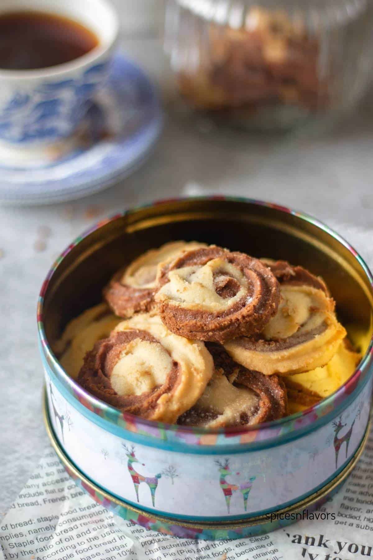vanilla chocolate butter cookies placed in a cookie tin