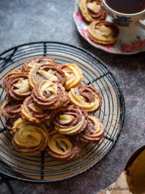 chocolate vanilla swirl butter cookies placed on a wire rack with black coffee on the side