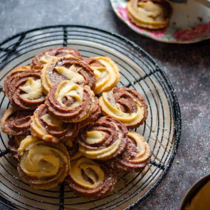chocolate vanilla swirl butter cookies placed on a wire rack with black coffee on the side