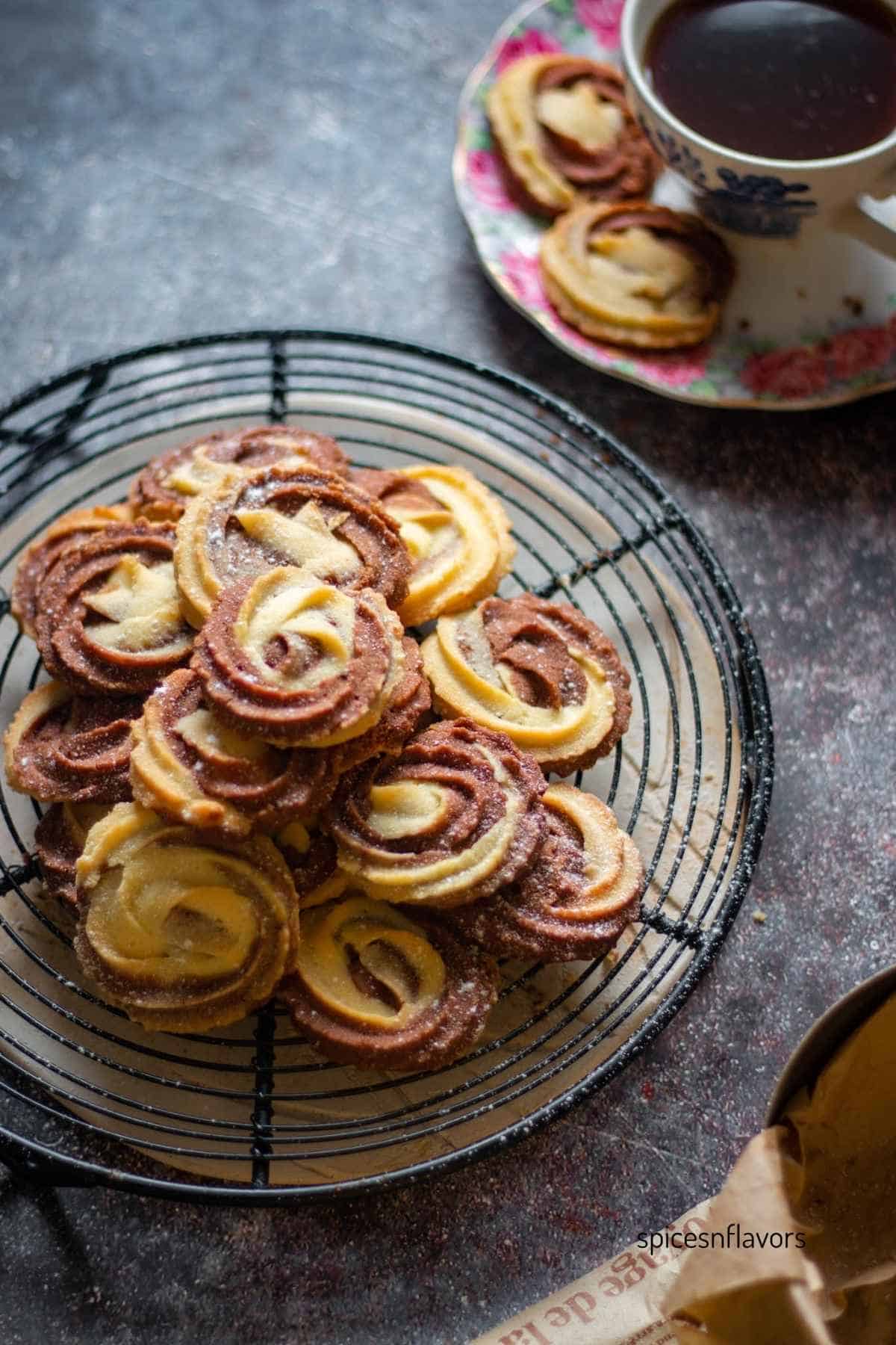 chocolate vanilla swirl butter cookies placed on a wire rack with black coffee on the side
