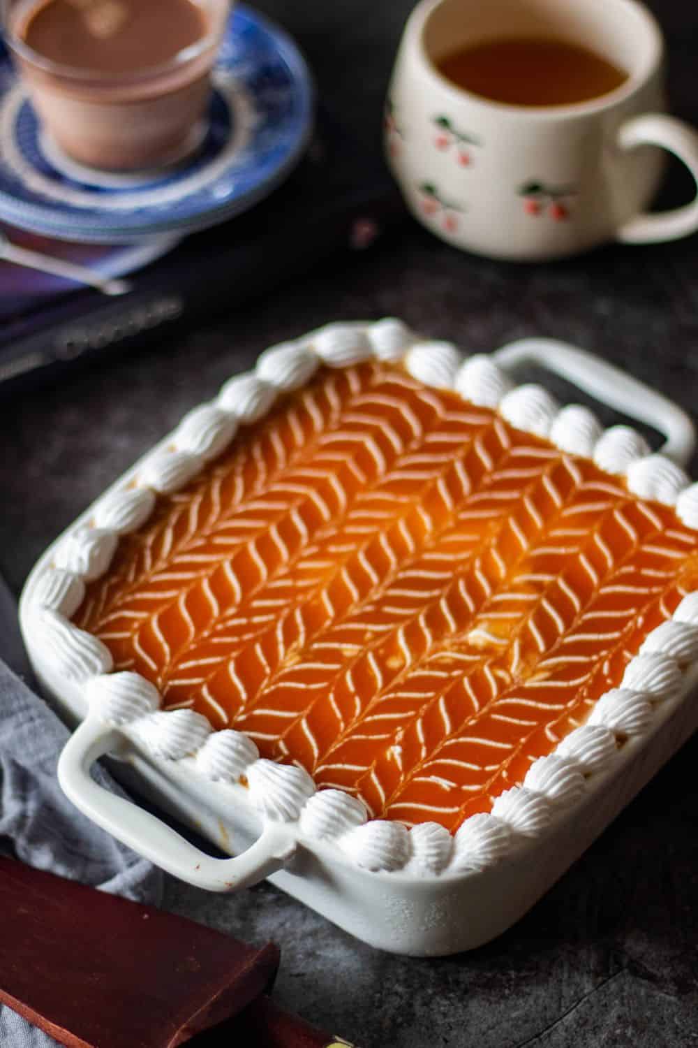 caramel tres leches cake with coffee in the background