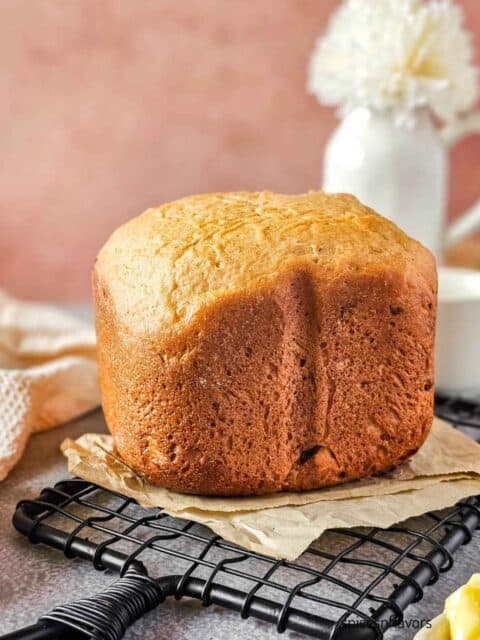 cinnamon raisin bread placed on a brown paper over a wire rack