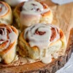 close up image of cinnamon rolls frosted with glaze to fit the recipe card image