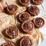 close up image of chocolate condensed milk cookies placed on brown paper to fit recipe card