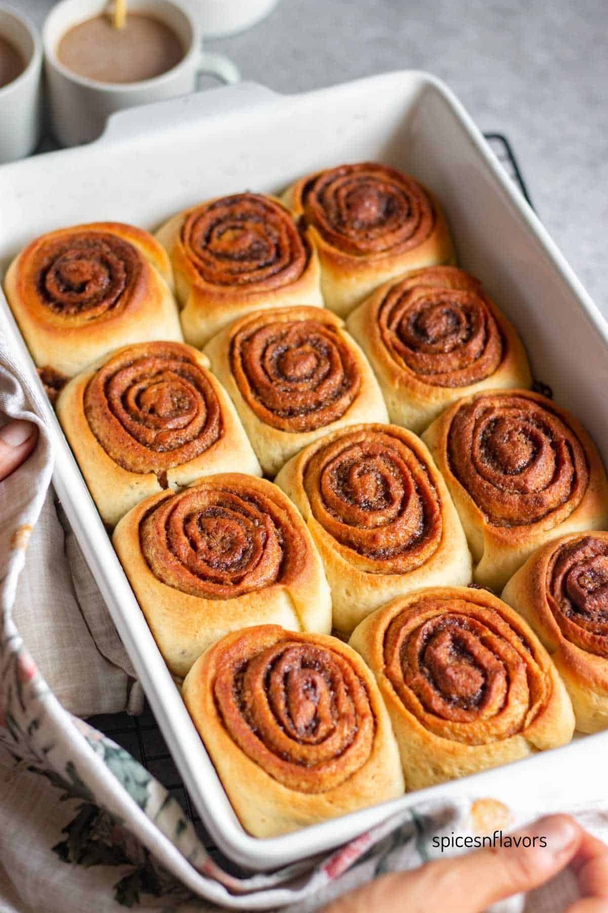 eggless baked cinnamon rolls placed in a baking dish