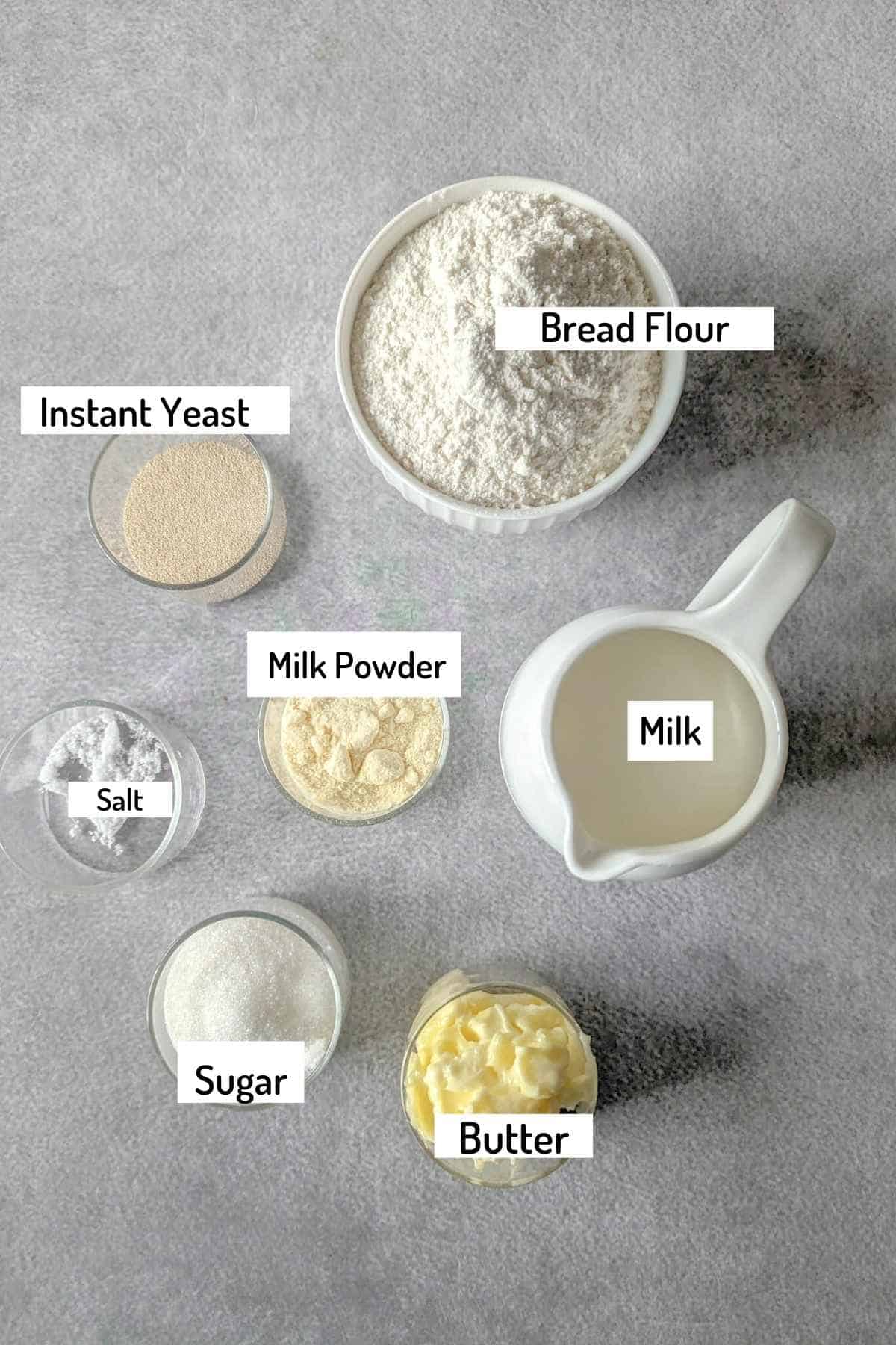 ingredients needed to make cinnamon rolls in bread machine laid on a sheet