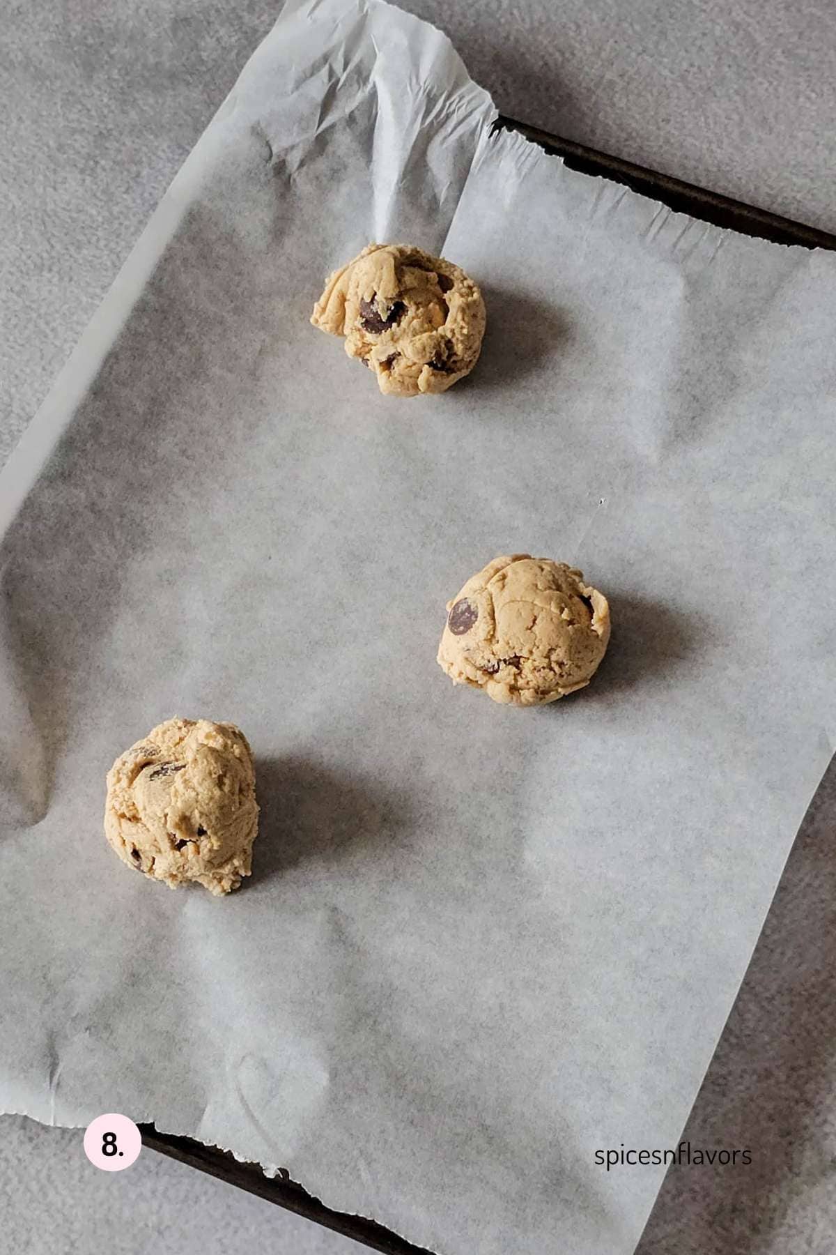 placing 3 cookie dough on to a baking tray