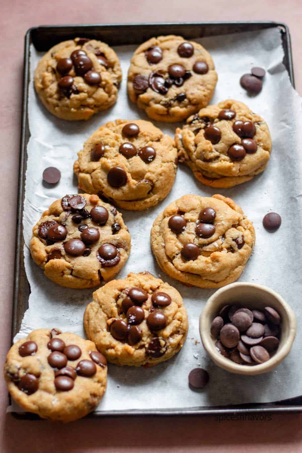 baked chai chocolate chip cookies placed on the baking tray lined with parchment paper